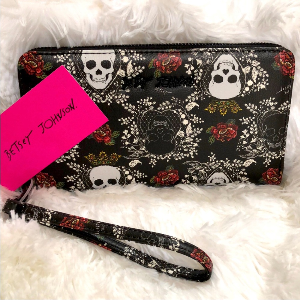 New Betsy Johnson wristlet wallet. Black with white skulls flowers and designs.
